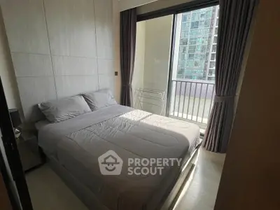 Cozy bedroom with balcony access in modern apartment