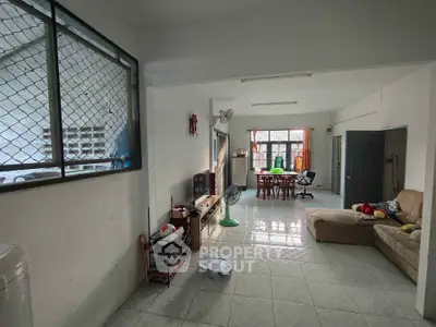 Spacious living room with tiled floor and natural light