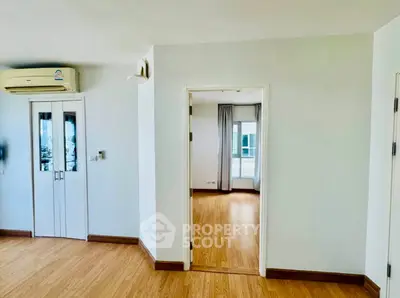 Spacious apartment interior with wooden flooring and natural light