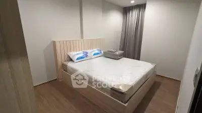 Cozy bedroom with wooden flooring and modern bed frame, perfect for restful nights.