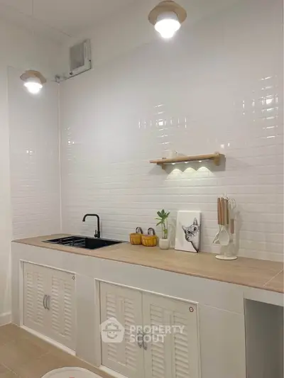 Modern kitchen with sleek white cabinets and stylish black faucet
