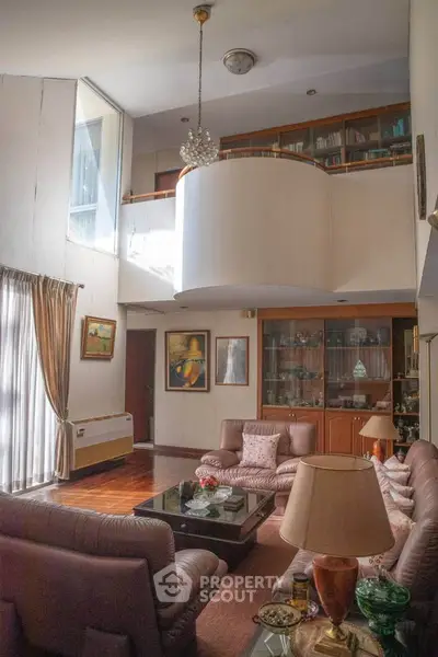 Spacious living room with high ceiling and elegant decor in a luxury home