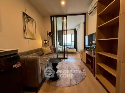 Modern living room with stylish decor and open view to bedroom