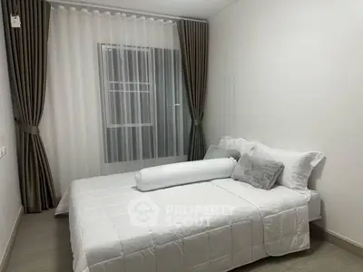 Cozy bedroom with elegant curtains and modern decor, perfect for restful nights.