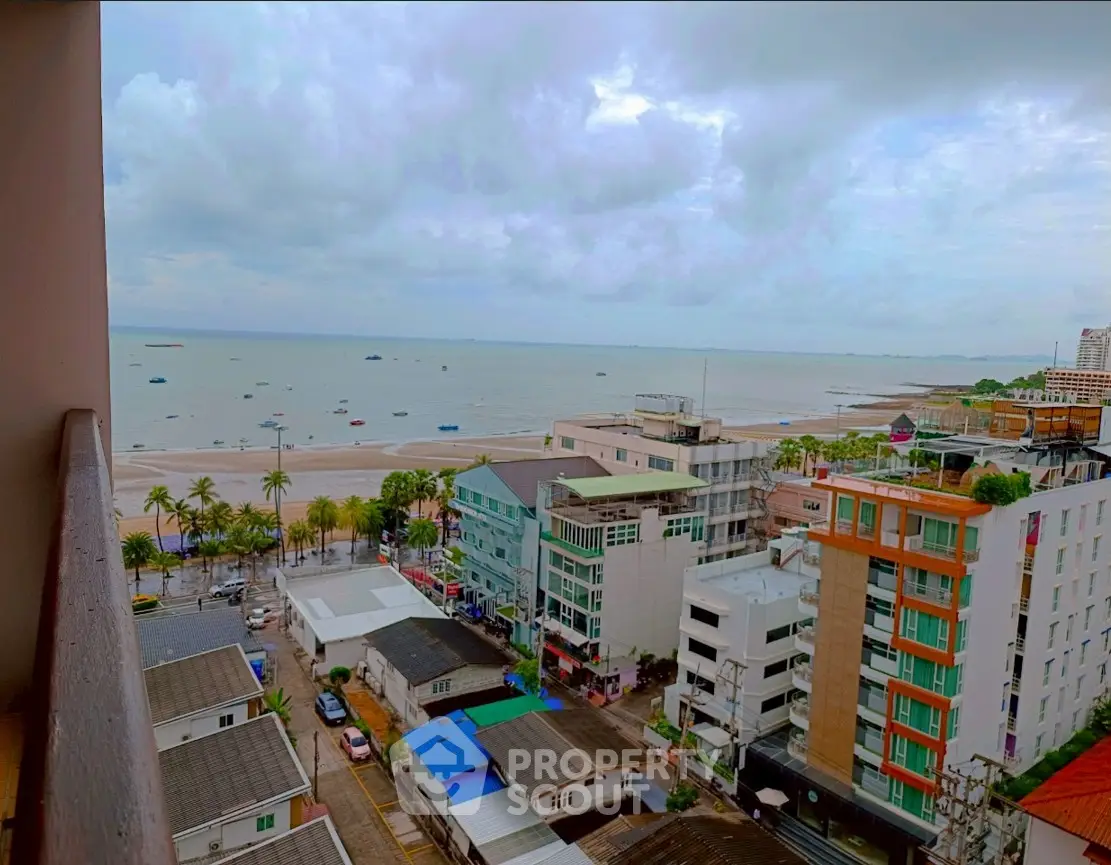 Stunning ocean view from high-rise balcony overlooking cityscape and beach, perfect for seaside living.