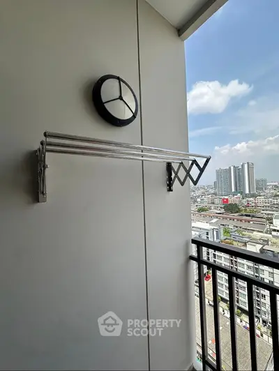 Modern balcony with city view and sleek drying rack, perfect for urban living.