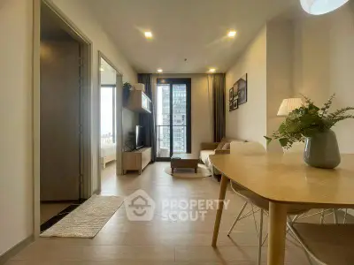 Modern living room with open layout and natural light in a stylish apartment.