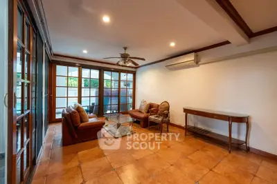 Spacious living room with elegant tile flooring and cozy seating area