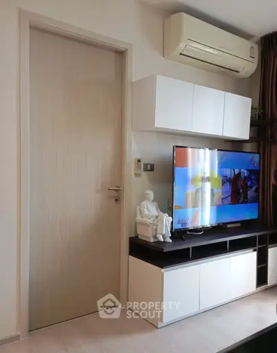 Modern living room with sleek TV unit and air conditioning, perfect for comfortable living.
