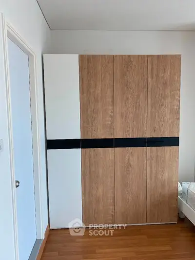 Modern bedroom with stylish wooden wardrobe and sleek design