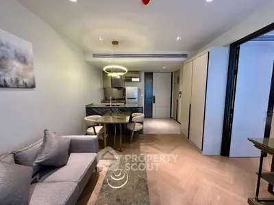 Modern living room with open kitchen layout and stylish furnishings