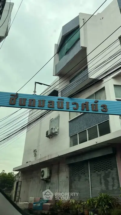 Modern urban building exterior with unique architectural design and street view.
