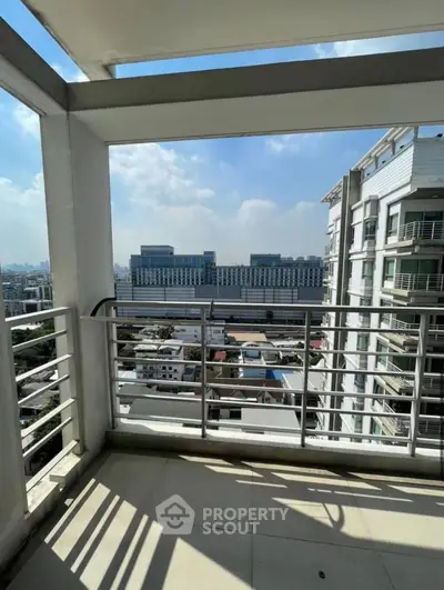 Spacious balcony with stunning city view in modern high-rise building