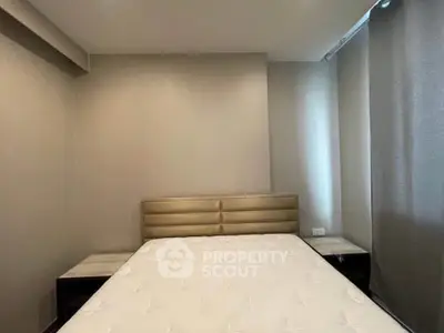 Cozy bedroom with modern design and neutral tones, featuring a comfortable bed and stylish headboard.