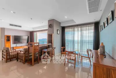 Spacious living room with stunning ocean view and elegant wooden furniture