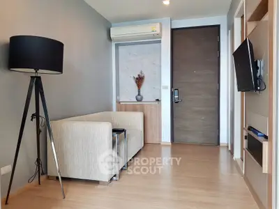 Modern living room with sleek design, featuring a cozy sofa, stylish floor lamp, and wall-mounted TV.