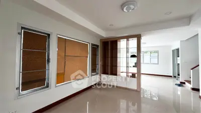 Spacious modern living room with built-in shelving and large windows