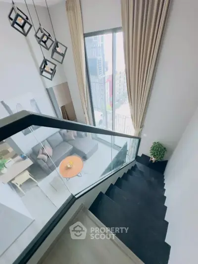 Modern duplex living room with high ceilings and stylish staircase