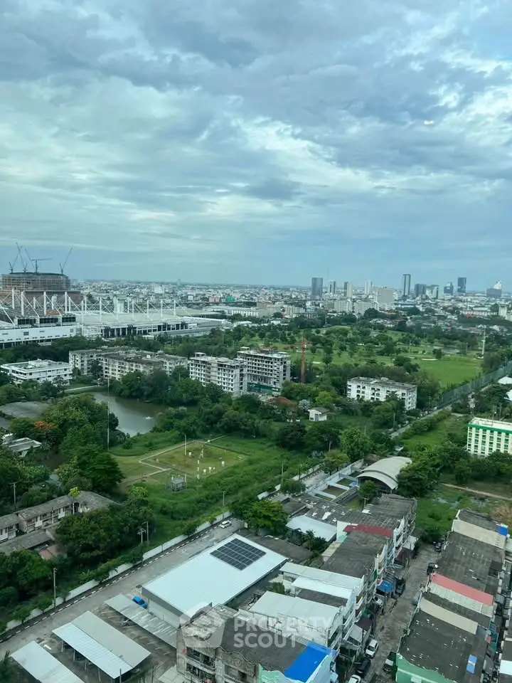 Stunning cityscape view from high-rise building showcasing urban and green landscapes.