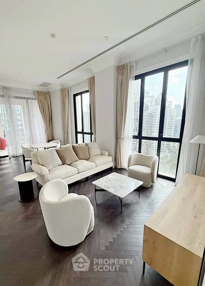 Luxurious living room with modern furniture and stunning city view through large windows.