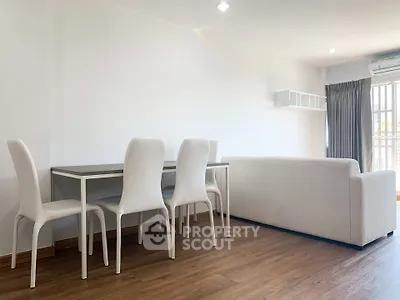 Spacious modern living room with white furniture and wooden flooring