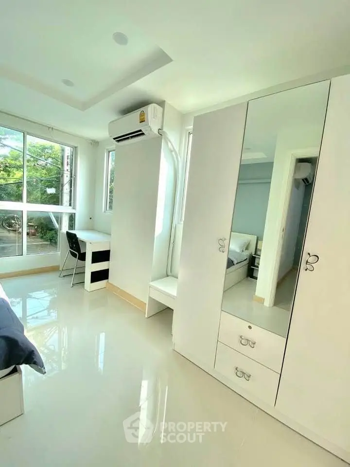 Bright and modern bedroom with large windows and sleek furniture