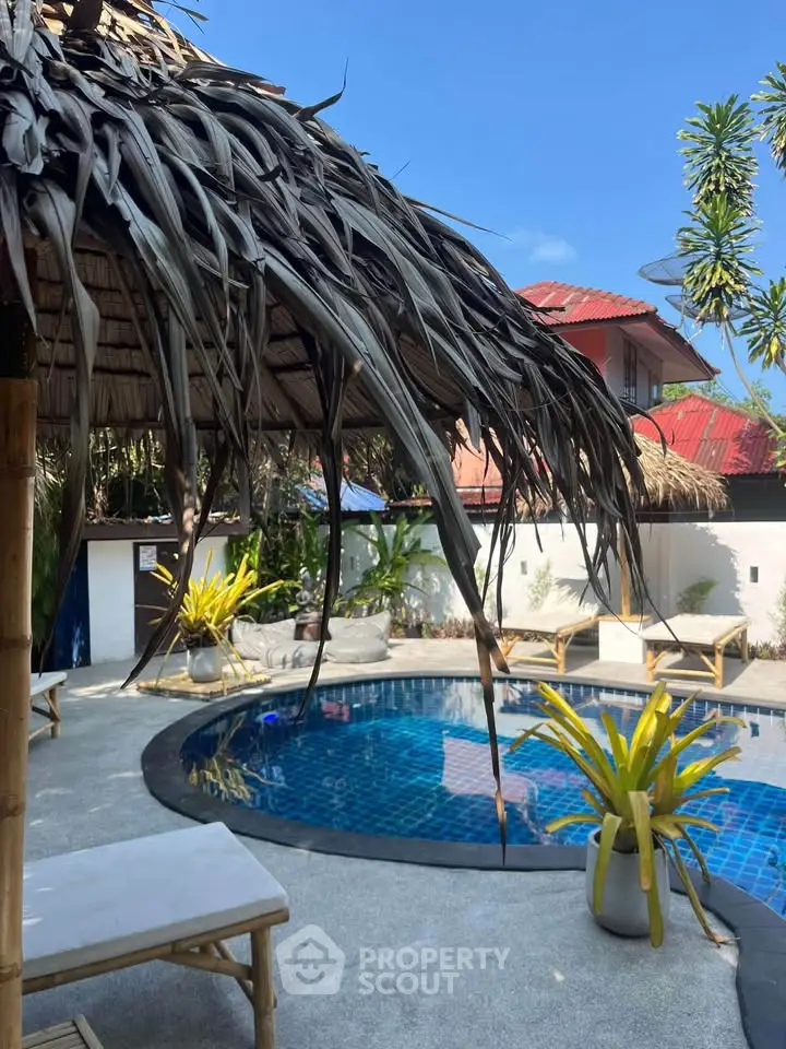 Tropical oasis with a serene pool and lush greenery, perfect for relaxation and luxury living.