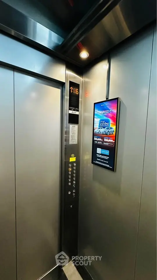 Modern elevator interior with sleek design and digital display panel