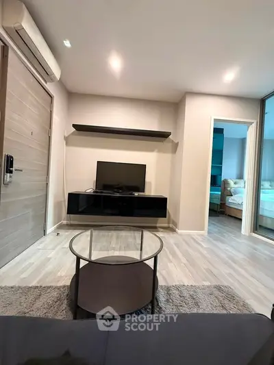 Modern living room with sleek design and open layout, featuring stylish furniture and contemporary decor.