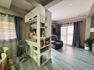 Stylish living room with modern bar setup and cozy seating area, perfect for entertaining guests.