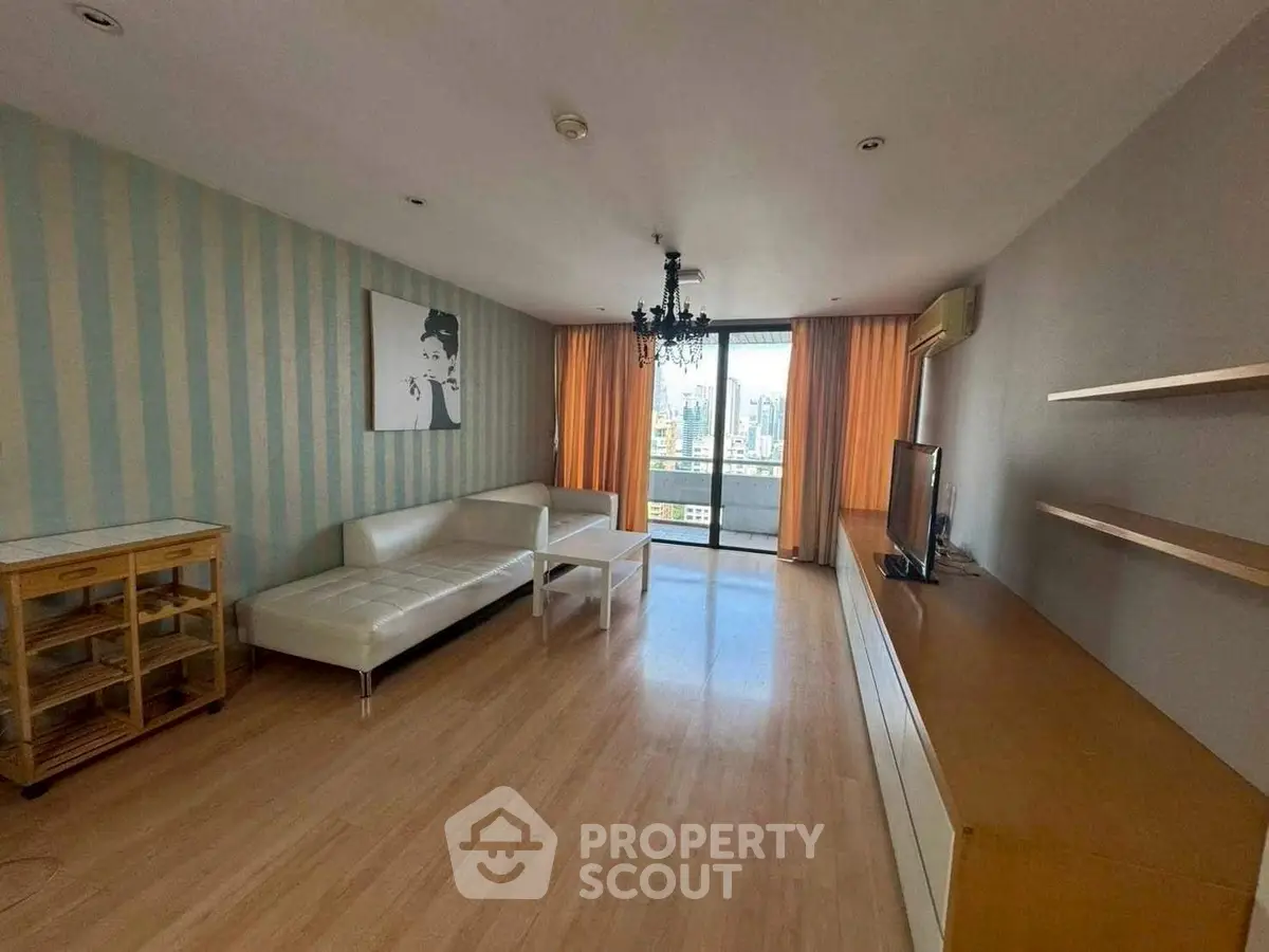 Spacious living room with modern decor and city view balcony