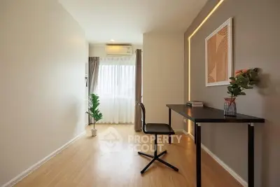 Modern study room with sleek desk and chair, natural light, and stylish decor.