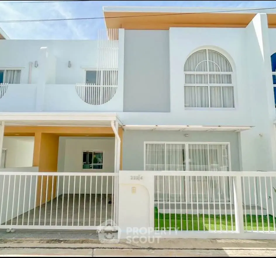 Modern two-story townhouse with gated entrance and stylish facade