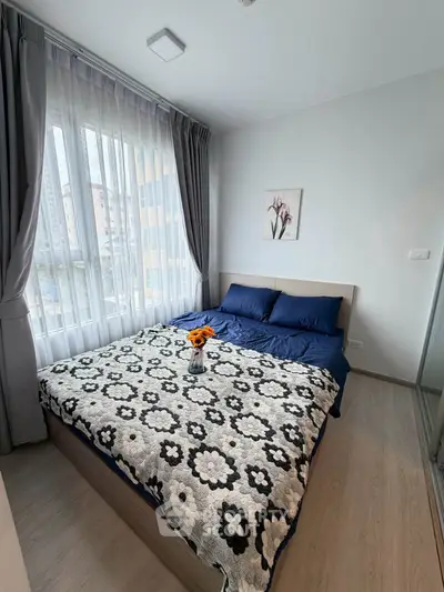 Cozy bedroom with large window and stylish decor in modern apartment