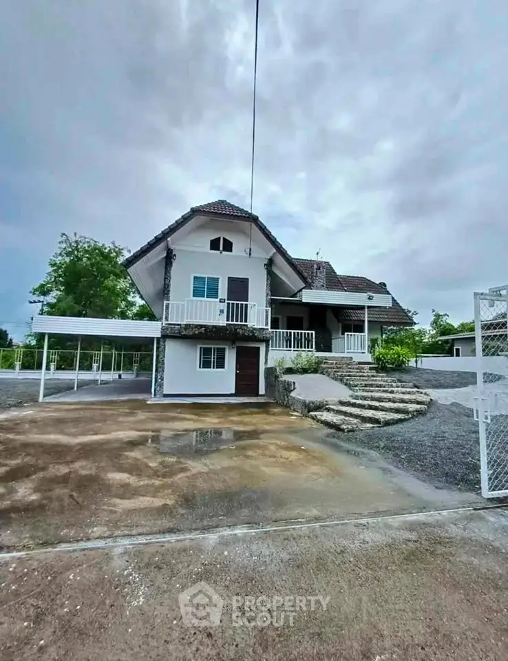 Charming two-story house with spacious driveway and lush surroundings.