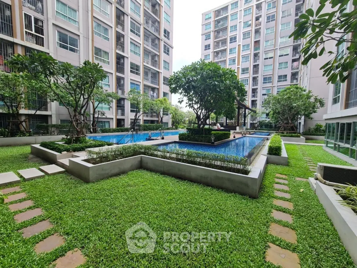 Luxurious condominium with lush garden and sparkling pool view