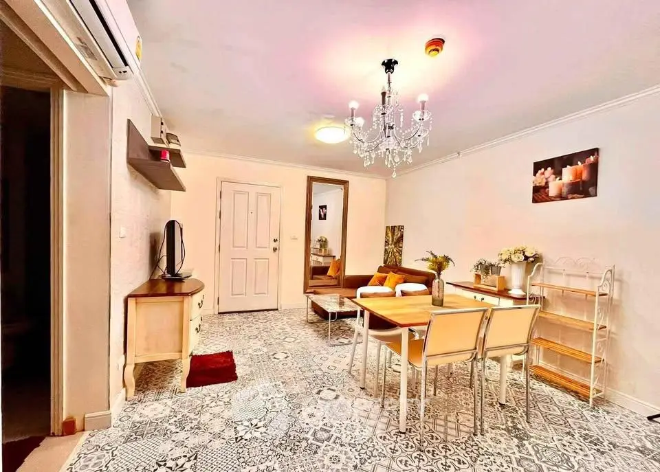 Charming living room with elegant chandelier and stylish decor, perfect for cozy gatherings.