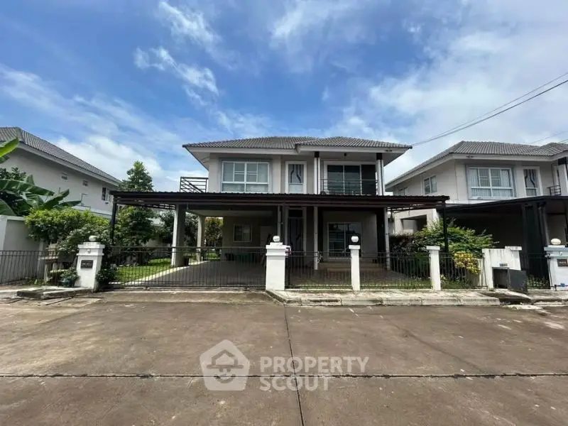 Spacious two-story house with modern design and large driveway in a serene neighborhood.