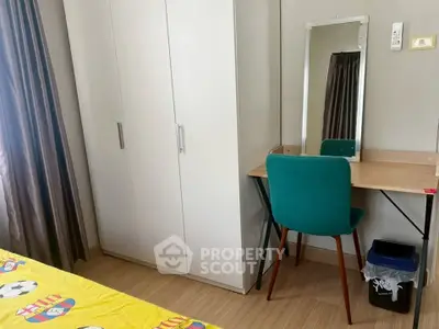Cozy bedroom with wardrobe and study desk, perfect for a comfortable living space.