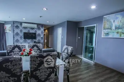 Elegant living room with stylish dining area and modern decor in a contemporary apartment.