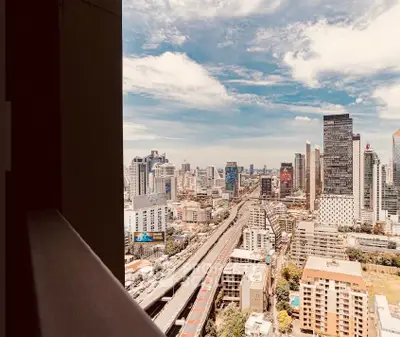 Stunning cityscape view from a high-rise balcony showcasing urban skyline and vibrant city life.