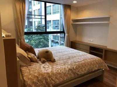 Cozy bedroom with large window and modern decor in urban apartment