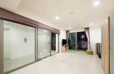 Spacious modern living room with city view and sleek interior design.