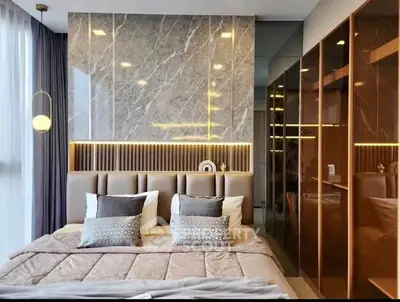 Luxurious modern bedroom with elegant design and stylish lighting, featuring a plush bed and mirrored wardrobe.