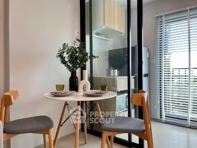 Modern dining area with glass partition and stylish kitchen view
