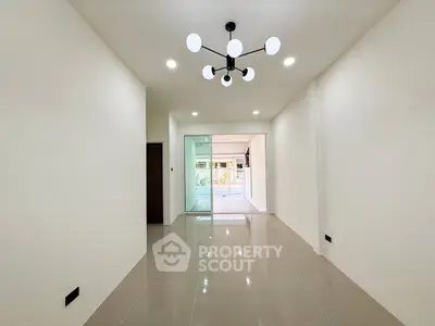 Spacious modern living room with elegant lighting and glossy tiled flooring