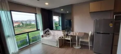 Modern living room with large windows and dining area, featuring a cozy sofa and sleek refrigerator.