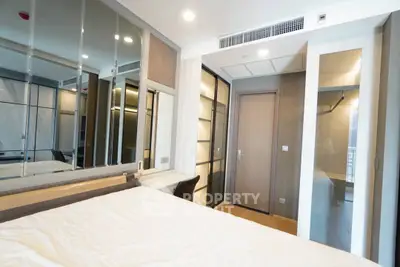 Modern bedroom with mirrored wardrobe and sleek design