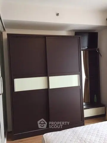 Modern bedroom with sleek wardrobe and cozy decor