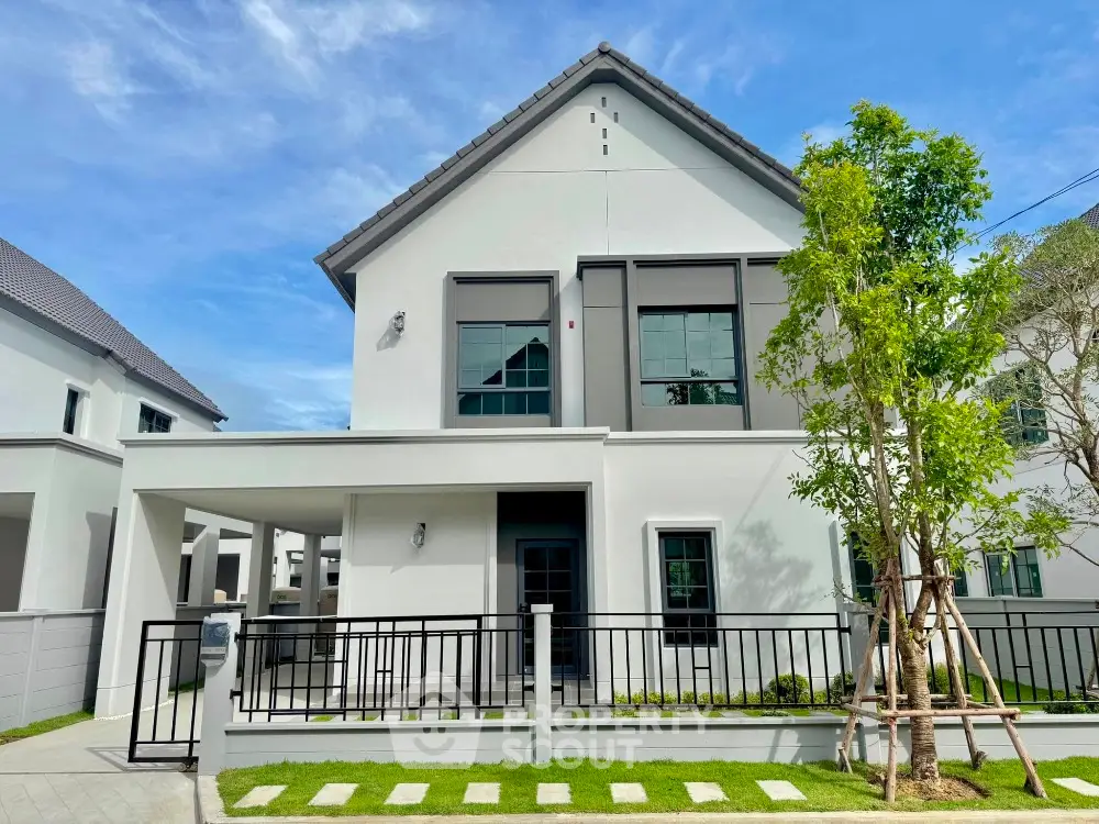 Modern two-story house with sleek design and spacious front yard